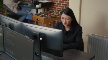 Programer focused on writing code encounters system failure while parsing algorithm sitting at desk