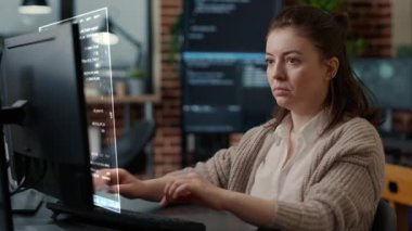 Caucasian system engineer working focused looking at vfx of floating computer screen with programming code