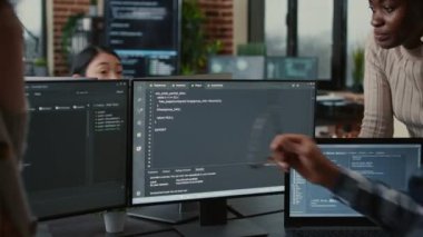 Software developers discussing about source code compiling discovers errors and asks the rest of the team for explanations