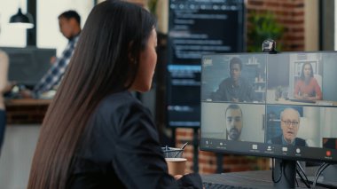 It startup employee in video call conference with client team discussing coding project