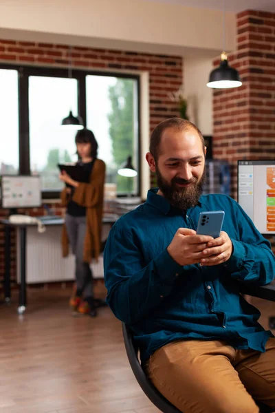 Businessman holding modern smartphone browsing on social media texting with remote friend — Φωτογραφία Αρχείου