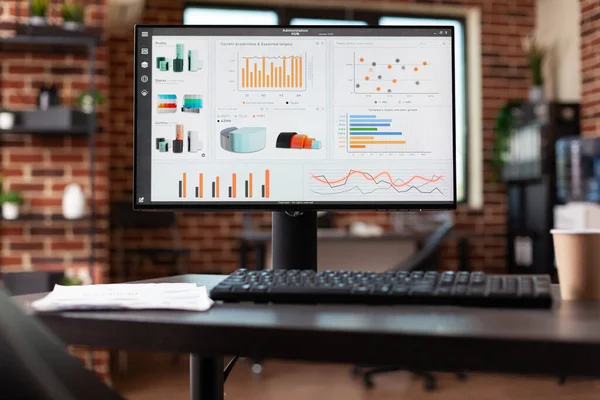 Close up of desk with business analysis charts on computer — Stockfoto