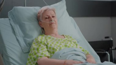 Hastane koğuşunda yatan yaşlı kadının portresi.