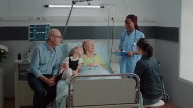 African american nurse giving advice to patient with disease and family in visit