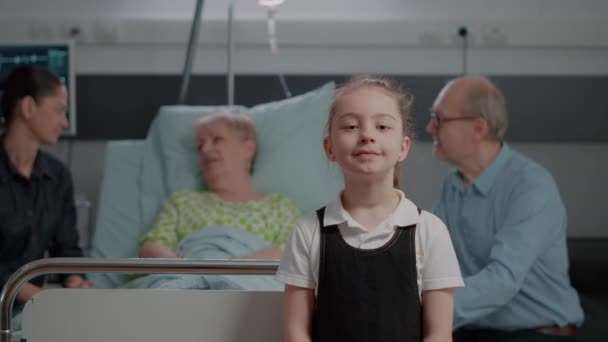 Portrait of young child standing in hospital ward at clinic — Video Stock