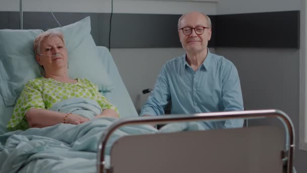 Portrait of senior people sitting in hospital ward — Stock Video