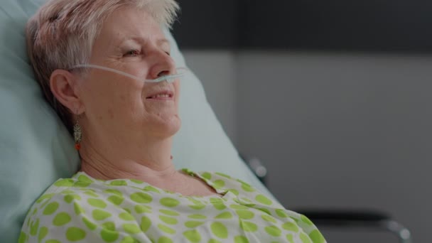 Close up of retired patient with illness having nasal oxygen tube — Stock video