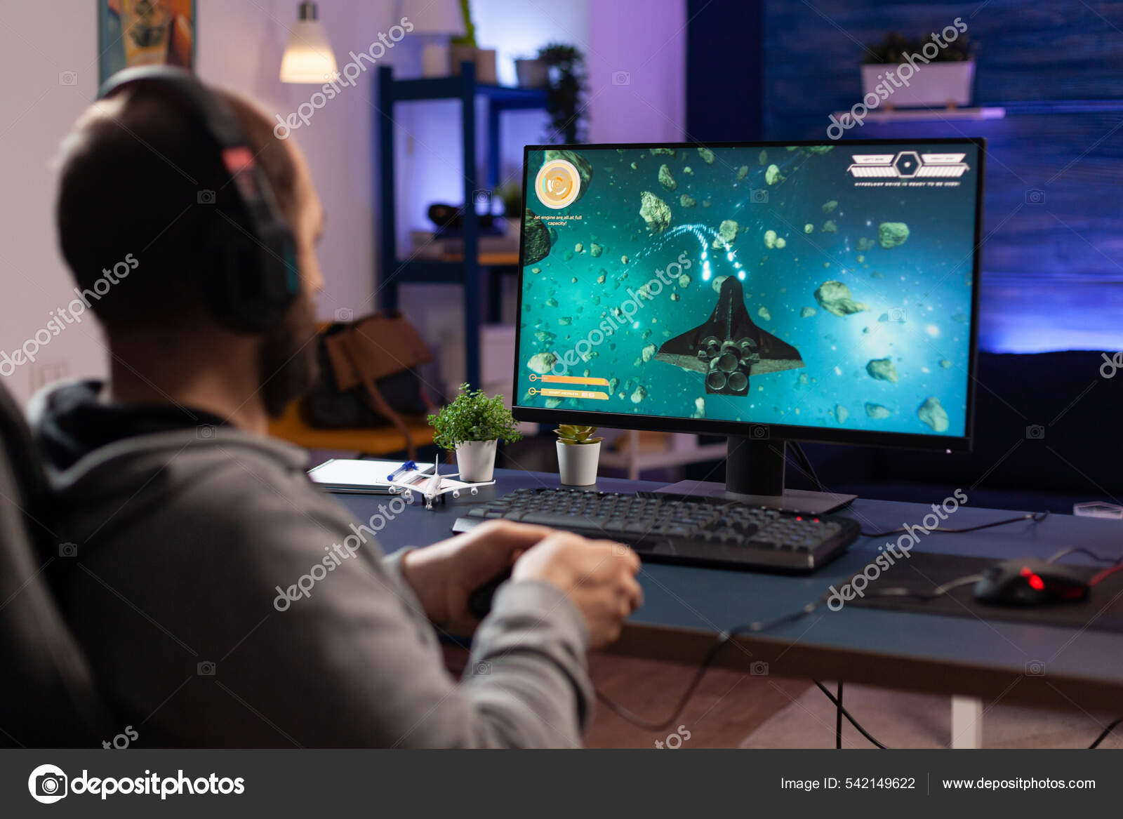 Free Photo  Gamer using controller to play online video games on computer.  man playing game with joystick and headphones in front of monitor. player  having gaming equipment, doing fun activity.