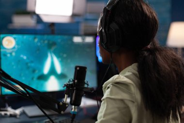 Successful esport gamer wearing headset talking with remote players