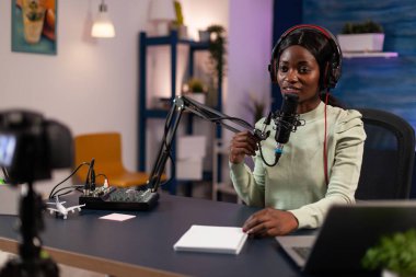 Social media influencer woman talking into production microphone