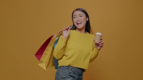 Mujer joven llevando bolsas de compras después de la compra al por menor — Vídeos de Stock