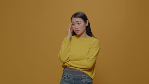 Asiatische Frau fühlt sich vor laufender Kamera besorgt und emotional — Stockvideo