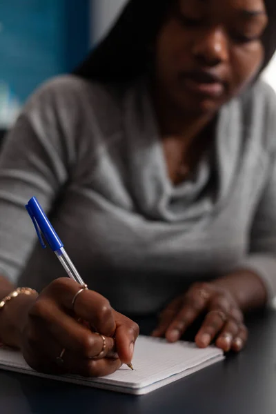Close-up van vrouw het maken van notities met pen op leerboek — Stockfoto