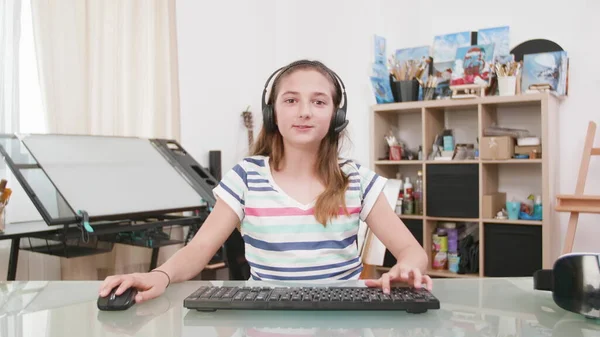 Portret małego dziecka ze słuchawkami grającymi w gry wideo podczas konkursu online — Zdjęcie stockowe