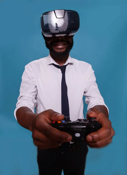 Ritratto del giocatore che tiene il controller wireless della console di gioco mentre indossa occhiali di realtà virtuale — Foto Stock