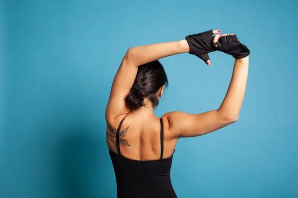 Back view of athletic trainer exercising gymnastic workout — Stock Photo, Image