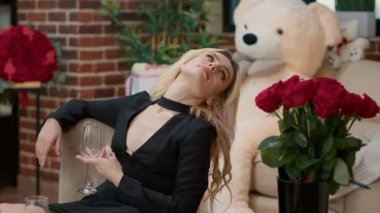 Boş şampanya bardağıyla sarışın seksi kadın erkek arkadaşını bekliyor.