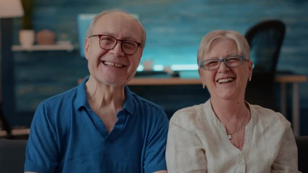 Portrait of cheerful grandparents laughing in front of camera — Stock Video