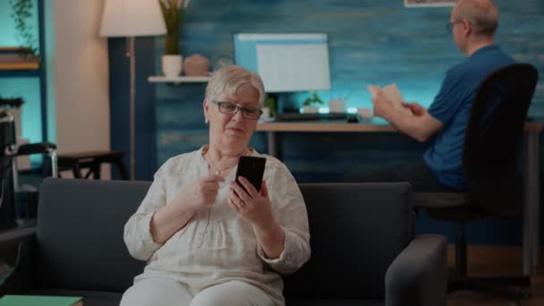 Mujer mayor charlando en videollamada remota en la sala de estar — Vídeo de stock