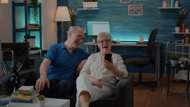 Pasangan senior berbicara dengan kerabat pada panggilan video online di rumah — Stok Video