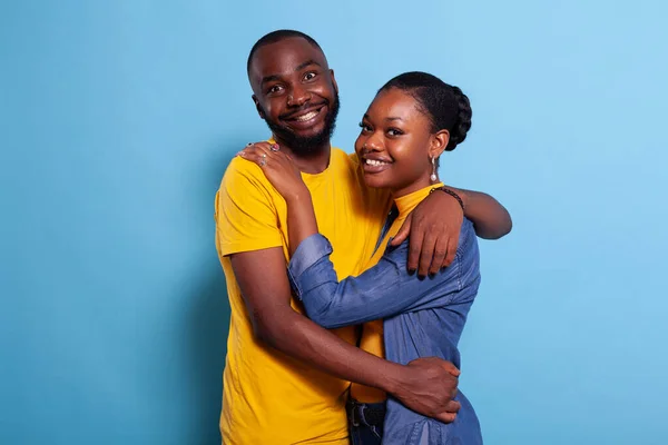Porträt eines romantischen Paares, das sich im Studio umarmt und lächelt — Stockfoto