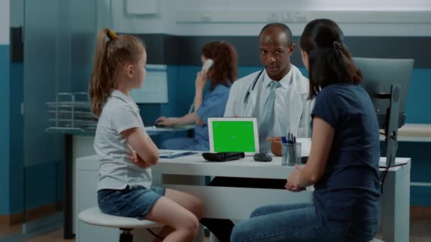 Trojnohý záběr pediatra s horizontální zelenou obrazovkou na tabletu — Stock video