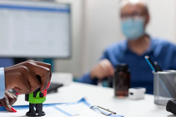 Closeup of therapist doctor hand stamping medication prescription — Stock Photo, Image