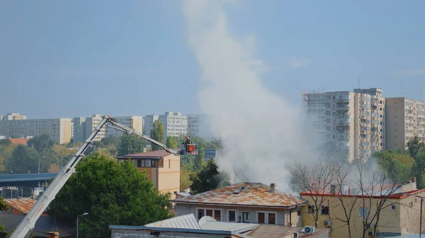 Сжигание домов в окрестностях города и помощь пожарных — стоковое фото