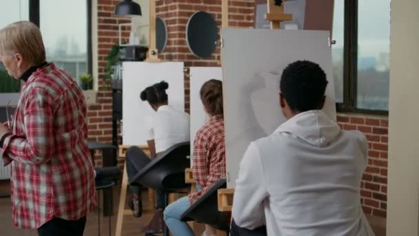 Mångsidig grupp elever som går på konstlektion i studio — Stockvideo