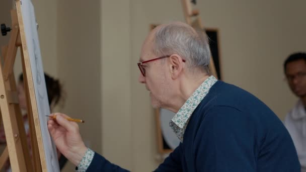 Portré idősebb diák segítségével ceruza rajzolni váza vázlat — Stock videók