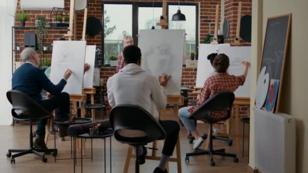 Oberlehrer beaufsichtigt Schüler beim Zeichnen von Vasenmodell auf Leinwand — Stockvideo
