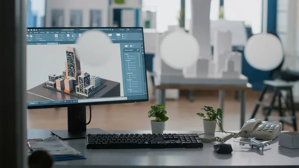 Detailní záběr monitoru s 3D budovou a dispozičním uspořádáním na stole v kanceláři. — Stock fotografie