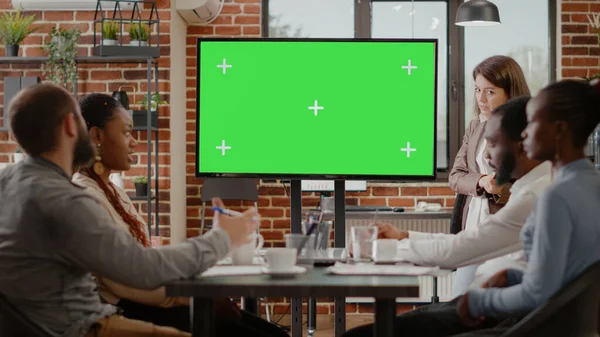 Workmates using isolated green screen on monitor