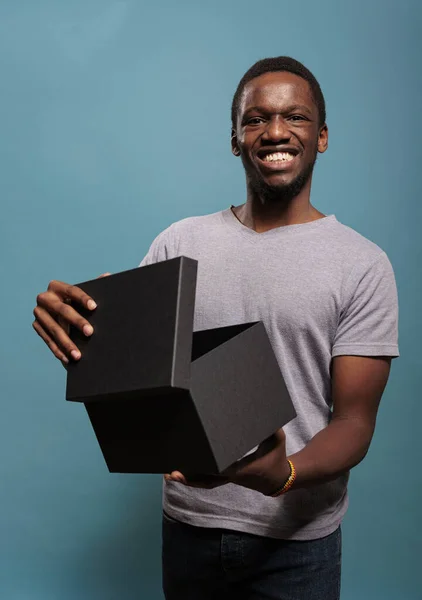 Shopaholic felnőtt nyitott ajándék doboz előtt a kamera — Stock Fotó