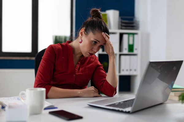 Fáradt üzletasszony ül a startup business desk nézi laptop képernyőn. — Stock Fotó