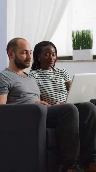 Interracial couple using video call communication at home — Stock Photo, Image