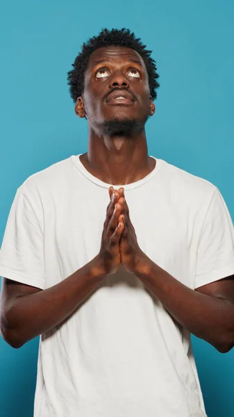 Man with faith praying to god begging for peace — Stock Photo, Image