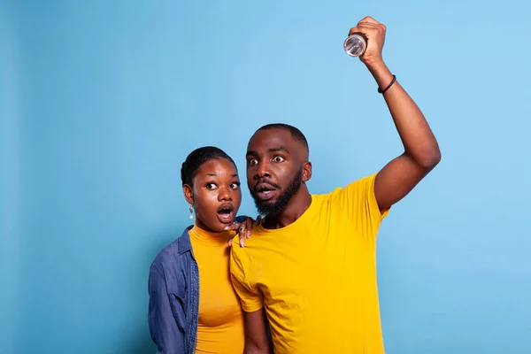 Scared man and woman checking problem with flashlight — Stock Photo, Image