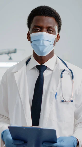 Portrait of man working as doctor with stethoscope and files — Stock Photo, Image