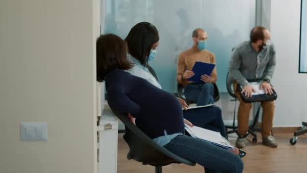 Mujer embarazada esperando en la cola para comenzar la entrevista de trabajo — Vídeos de Stock