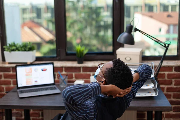 Tired startup business owner stretching and taking a break from working on laptop — Stock Photo, Image
