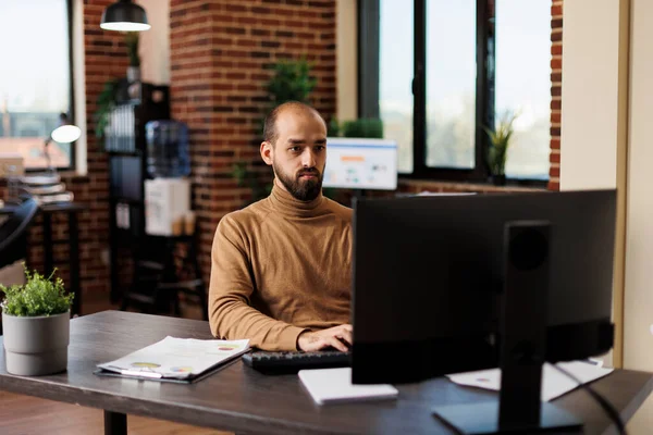 Jefe de equipo del departamento de investigación que trabaja en soluciones financieras mientras está sentado en el escritorio y utiliza la computadora de trabajo. — Foto de Stock