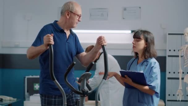 Старший пацієнт проводить вправи з відновлення в медичному кабінеті — стокове відео