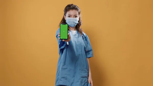 스마트폰을 들고 녹색 화면 흉내를 내는 청진기를 가진 의사와 문자 메시지 — 스톡 사진
