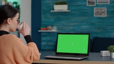 Laptop bilgisayarında yeşil ekrana bakan genç öğrenci