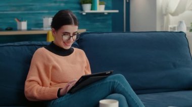 Araştırma projesi yaratmak için dijital tablet üzerinde çalışan kız öğrenci