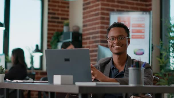 Portrait of happy man using laptop to work on company statistics — Stock Video