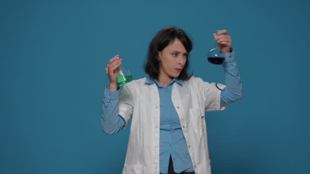 Mujer química analizando sustancia genética en vasos de precipitados de laboratorio — Vídeos de Stock