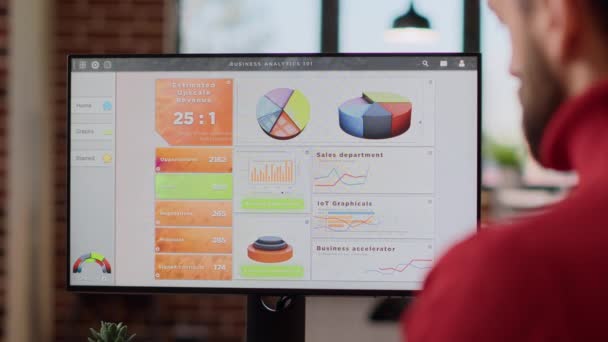 Irodai dolgozó üzleti térképeket és grafikonokat elemez a monitoron — Stock videók