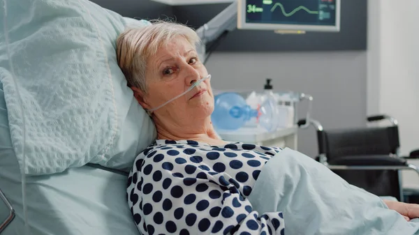 Ritratto di vecchio paziente disteso a letto con tubo di ossigeno nasale — Foto Stock
